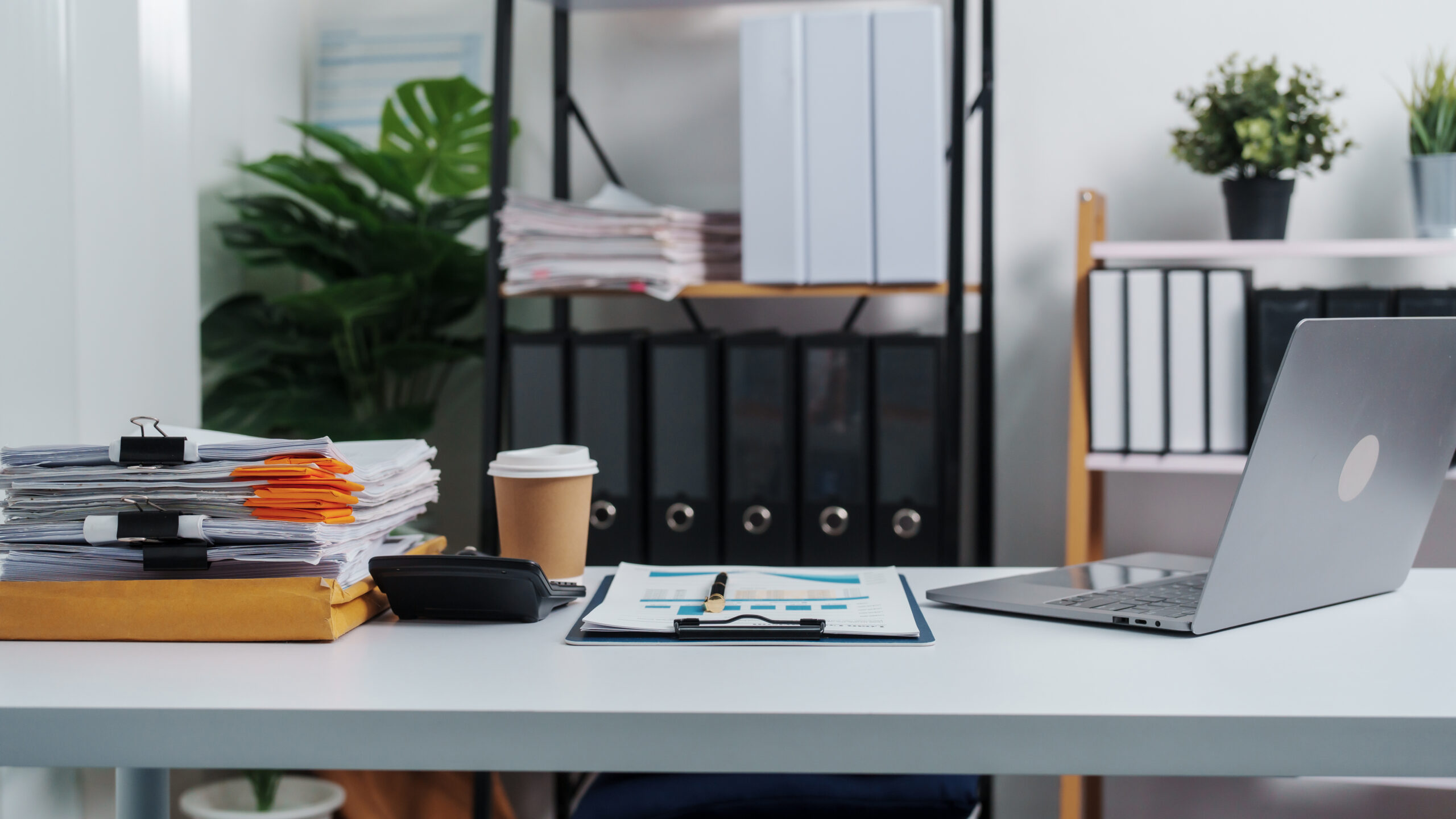 Stylish workspace with laptop, notebook, blank screen laptop on